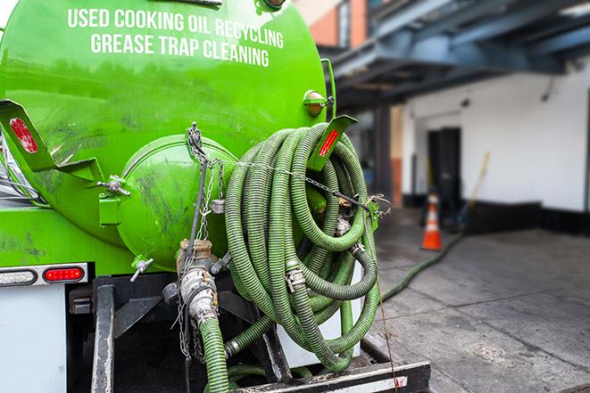 a service truck pumping grease from a restaurant's grease trap in Alvada